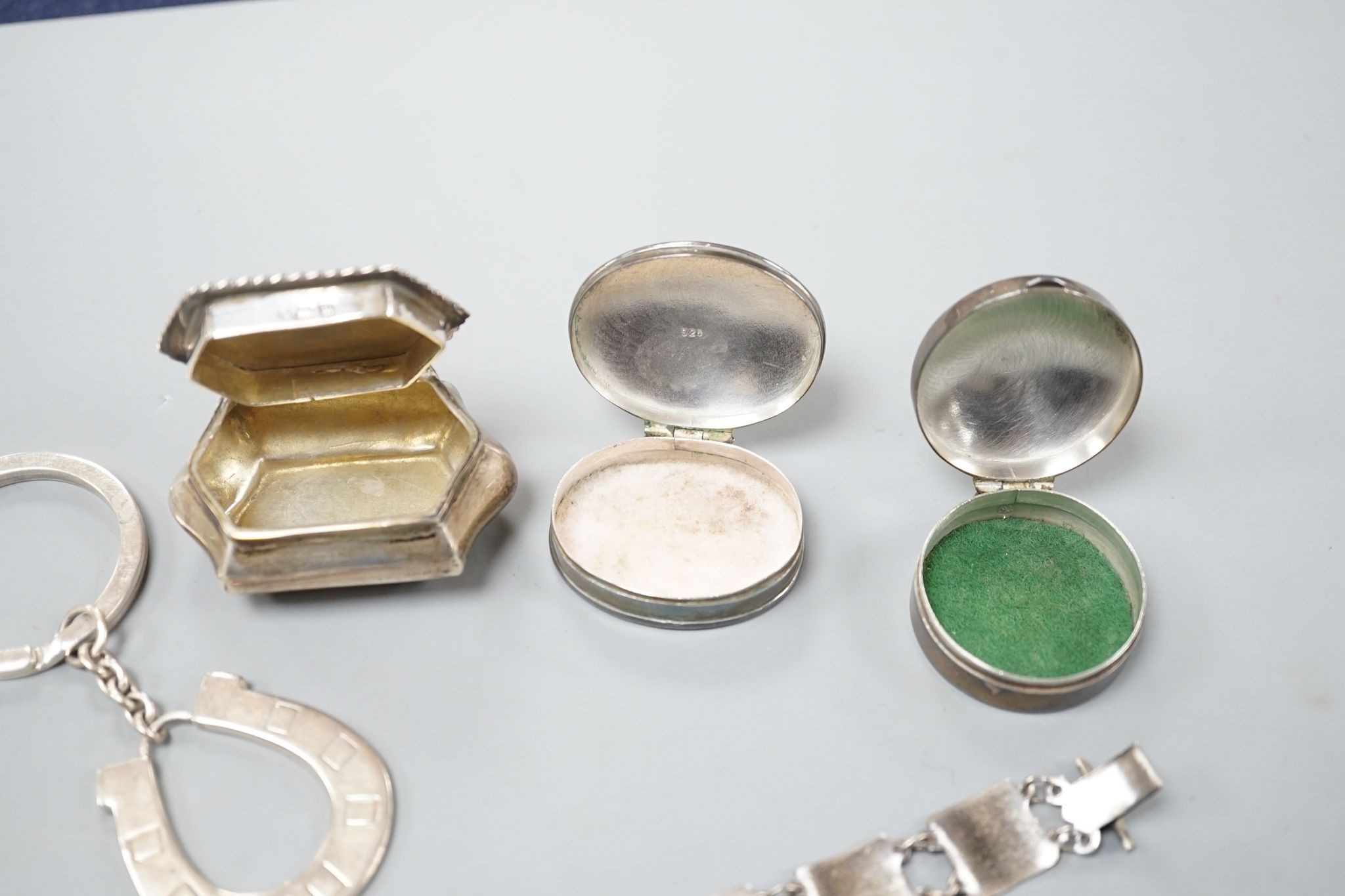 Three silver pill boxes, a key ring and white metal and niello bracelet.